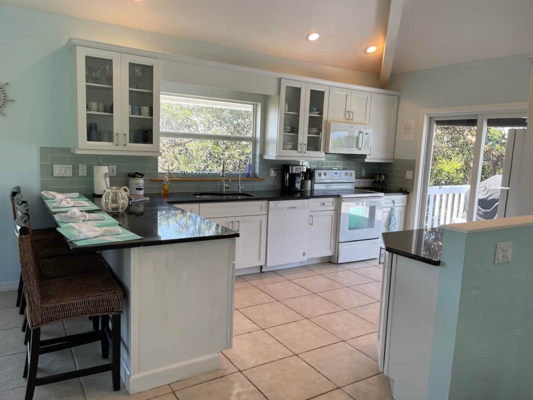 Kitchen with 4 bar seats. Over stocked with everything you need for large family meals.
