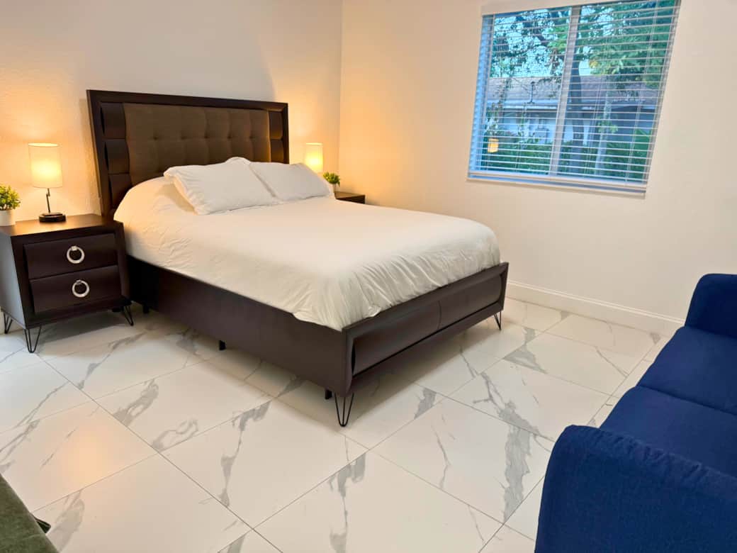 Comfortable primary bedroom with queen bed, crisp cotton sheets, and a calm, relaxing atmosphere.