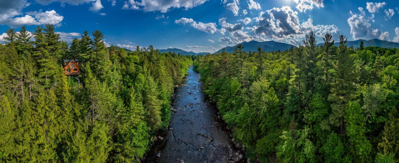 Wilmington Range Chalet drone 180 degree panorama over Ausable River summer