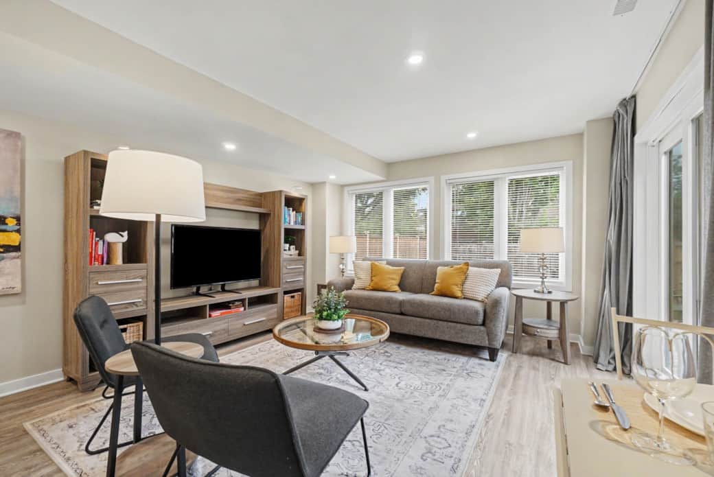 Spacious, inviting open-concept living room complete with comfortable seating, a large 49" smart TV, Spacious, inviting open-concept living room complete with comfortable seating, a large 49" smart TV,