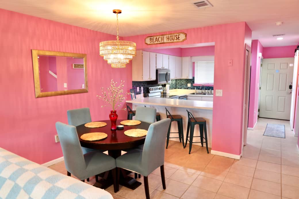 Dining area, bar stools, and kitchen