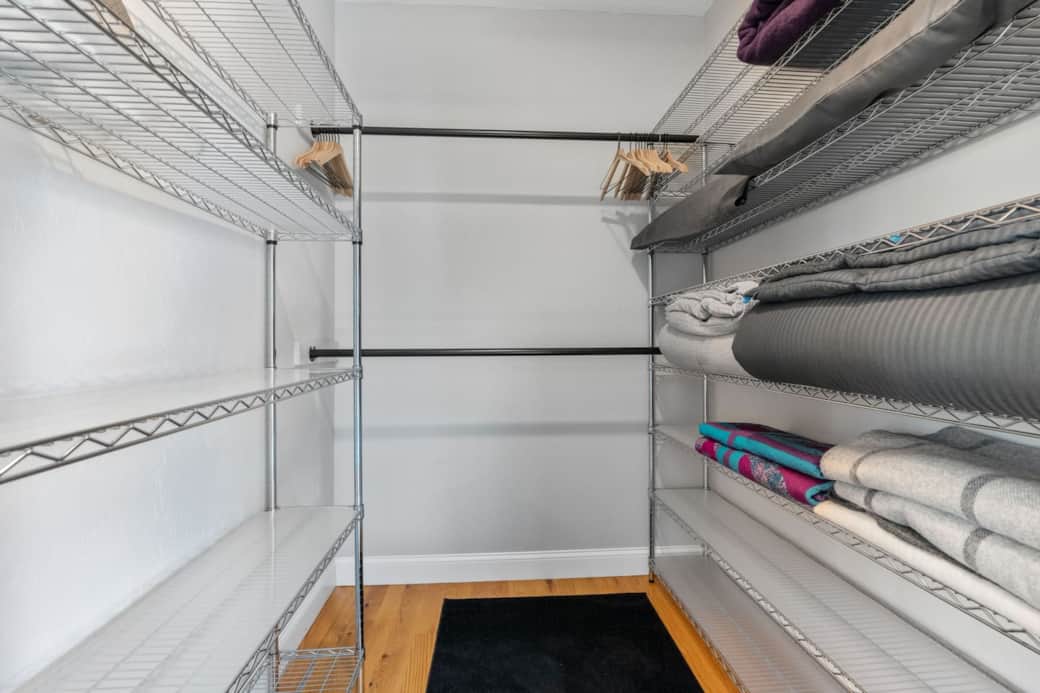 Large walk-in closet with plenty of storage, spare blanks and pillows. Large walk-in closet with plenty of storage, spare blanks and pillows.