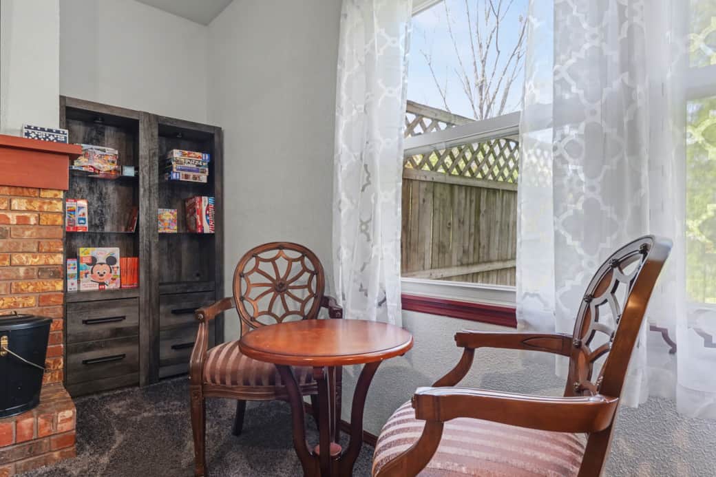 Family Room with a large Roku TV, a work area with a monitor and power, plenty of seating and games.
