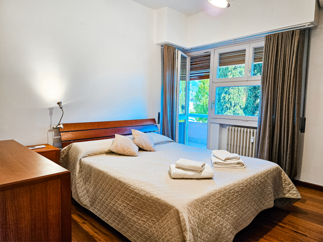 Double bedroom with blackout curtains and shutters