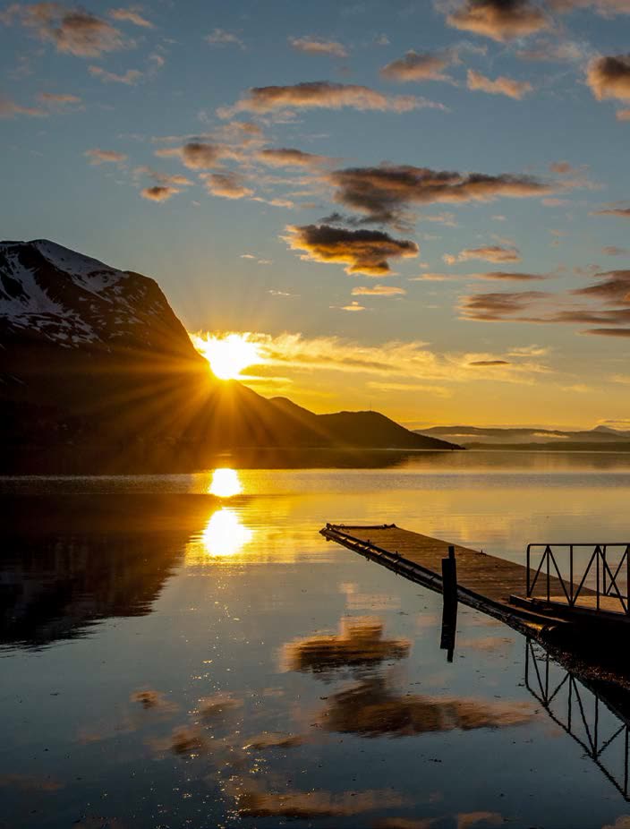 Midnight sun over the fjord jetty