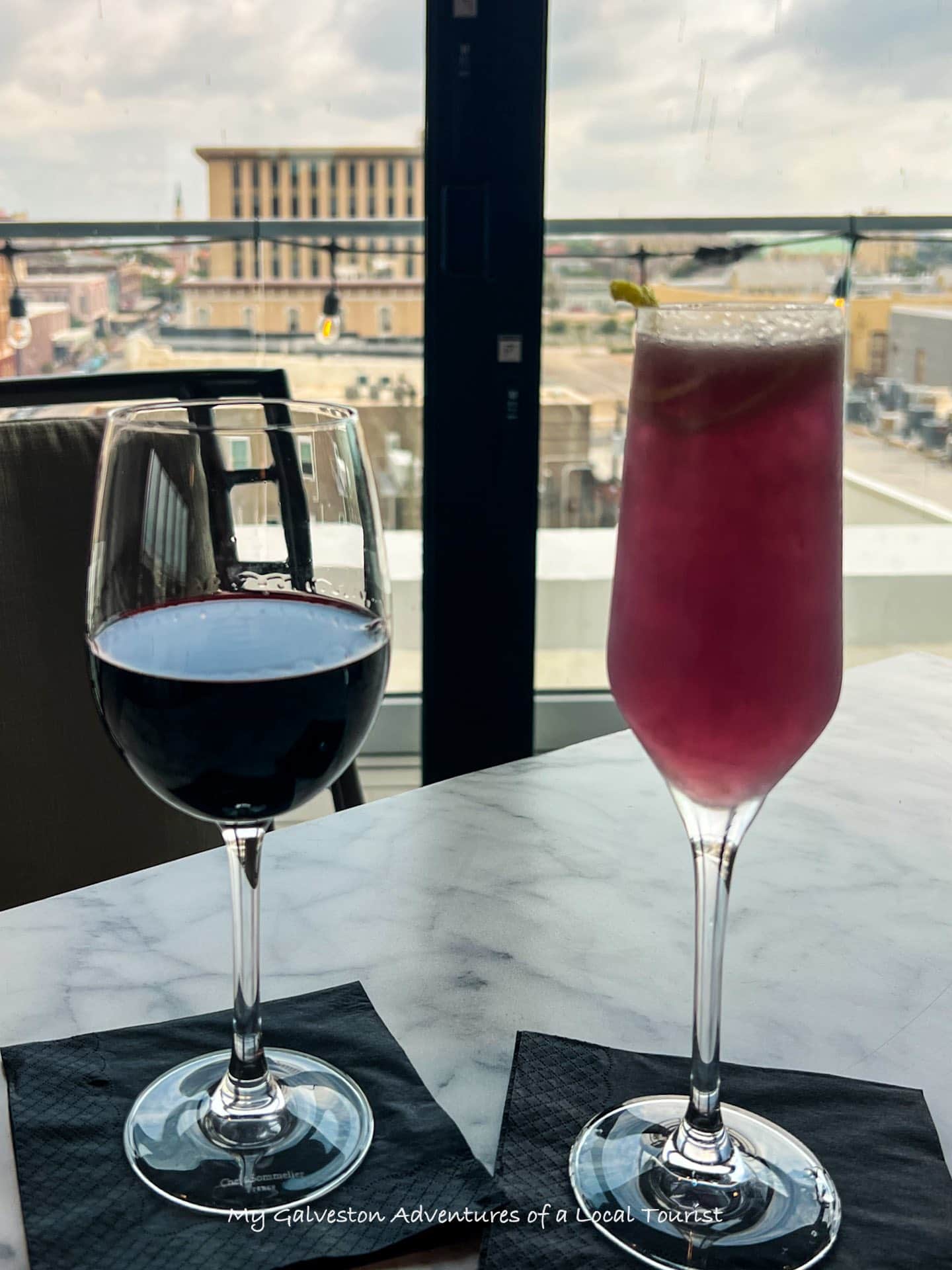The Rooftop Bar at The Tremont House in Galveston, Texas overlooking the Historic Strand District at sunset.  Image taken by Kelly Chapman with My Galveston: Adventures of a Local Tourist Facebook page.