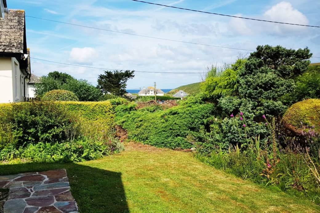 View of the sea from the front garden. Numerous lawnded areas.