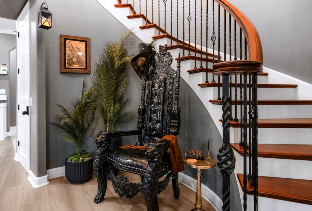 Gaspar’s throne sits regally beneath the curved staircase, flanked by palms and pirate relics. Gaspar’s throne sits regally beneath the curved staircase, flanked by palms and pirate relics.
