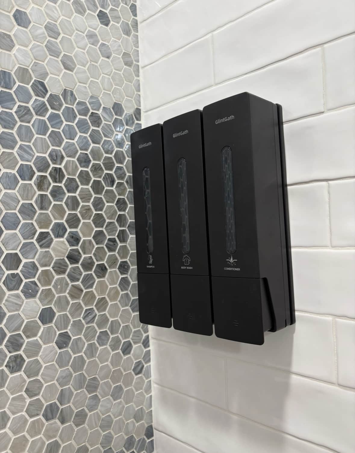 Shampoo, body wash, and conditioner dispenser for guests.