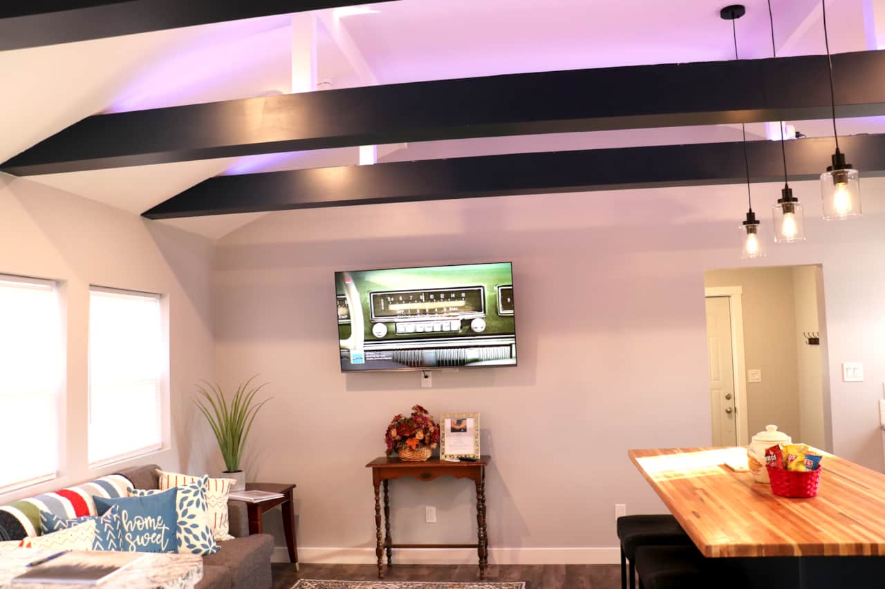 Living room Roku Tv with illuminated beams overhead that can be adjusted for ambiance
