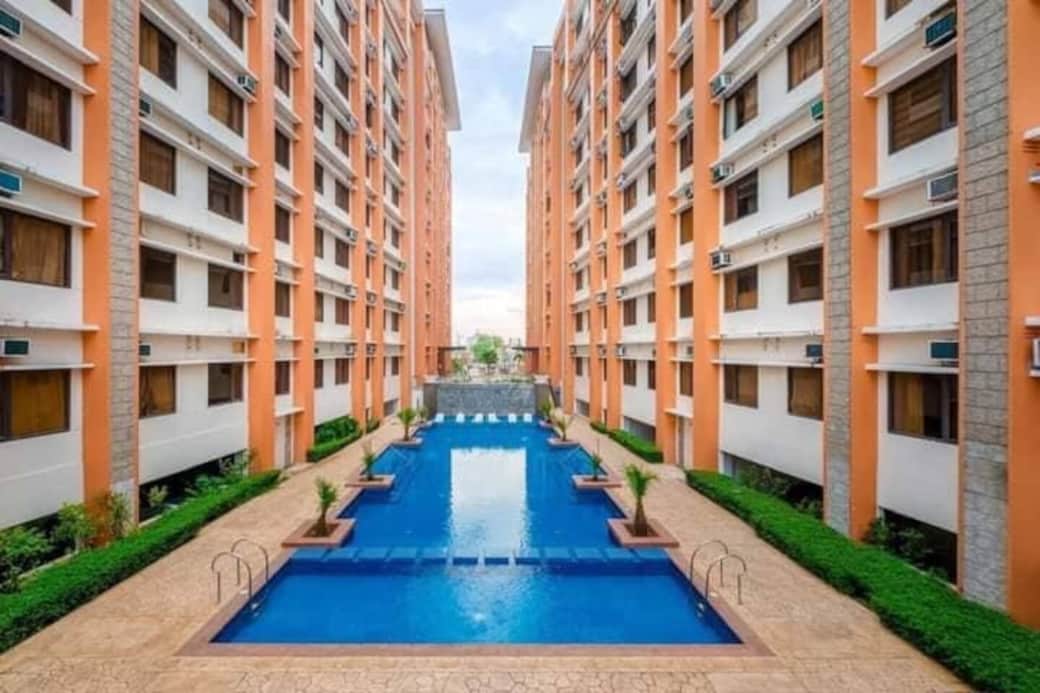 ned Paseo Verde swimming pool — a serene oasis surrounded by lush greenery. Perfect for a refreshing dip, relaxing afternoons, or socializing in a peaceful, upscale setting.