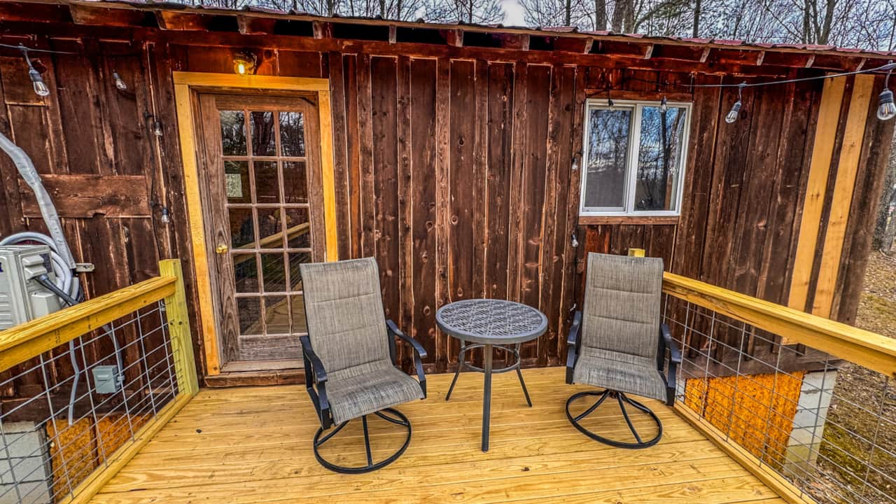 Private covered deck with seating at a Stay KY cabin