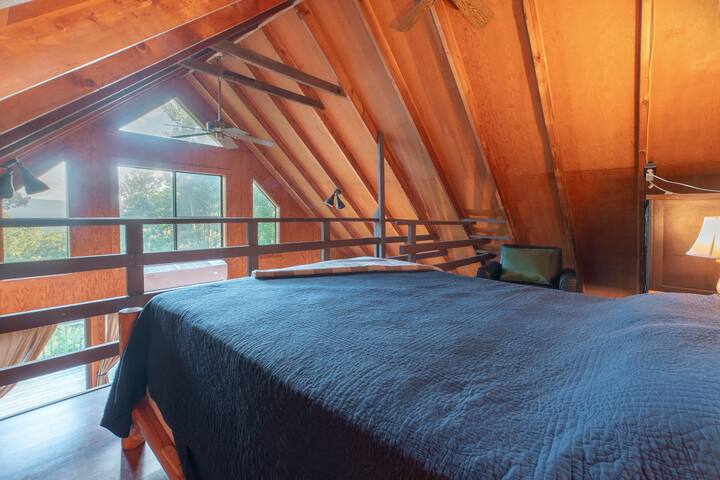 Unique loft bedroom space offers majestic views of the mountains.