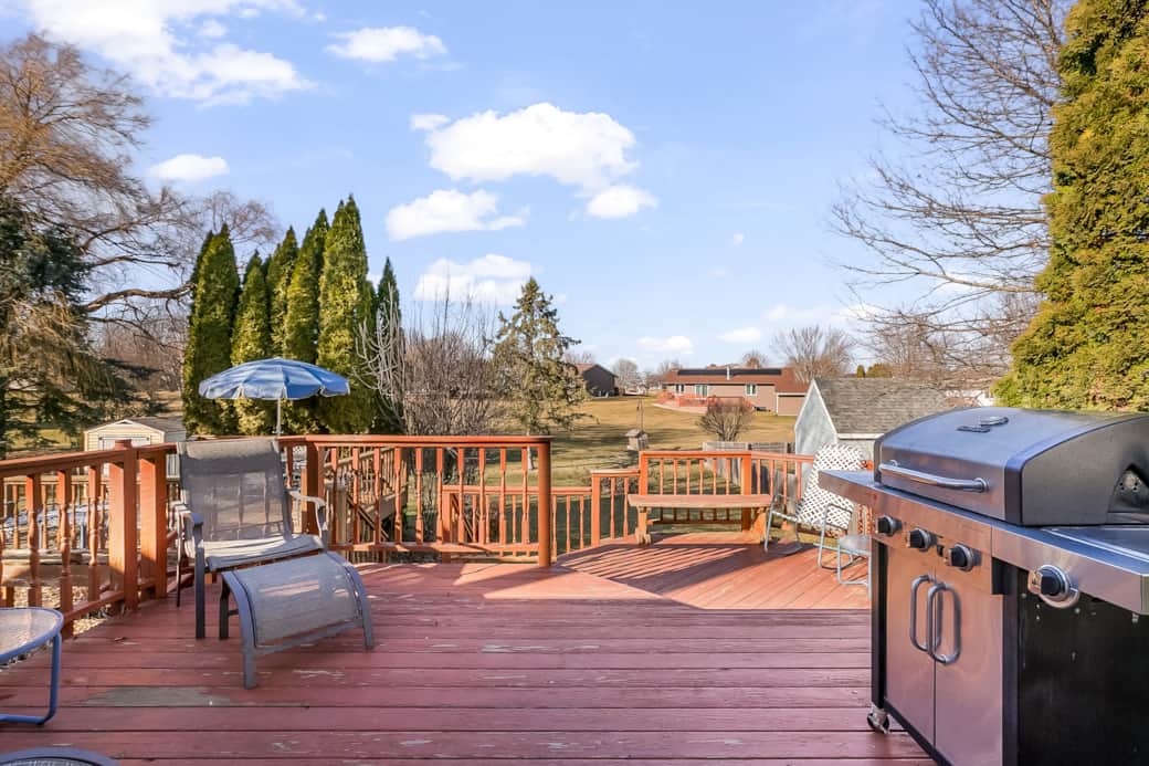 Large Deck that overlooks the backyard. The grill is propane