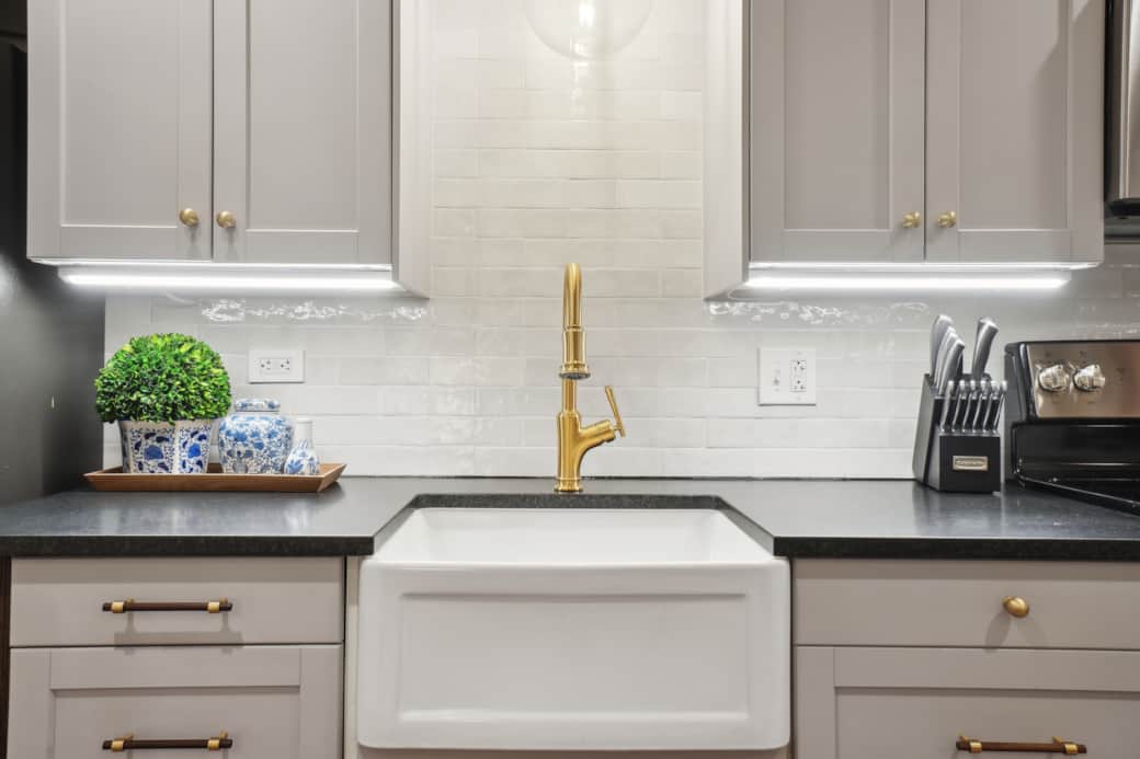 The custom kitchen has honed granite counters, under cabinet lighting, and hand-cut tile backsplash.