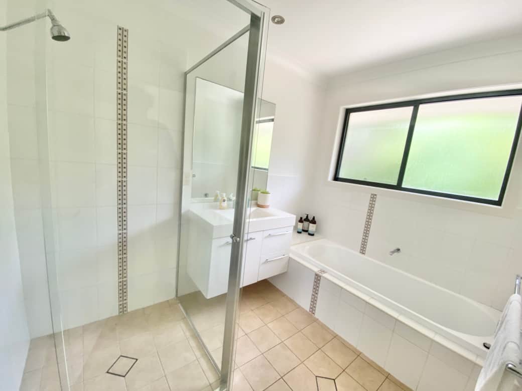 Bright bathroom with glass shower and bath