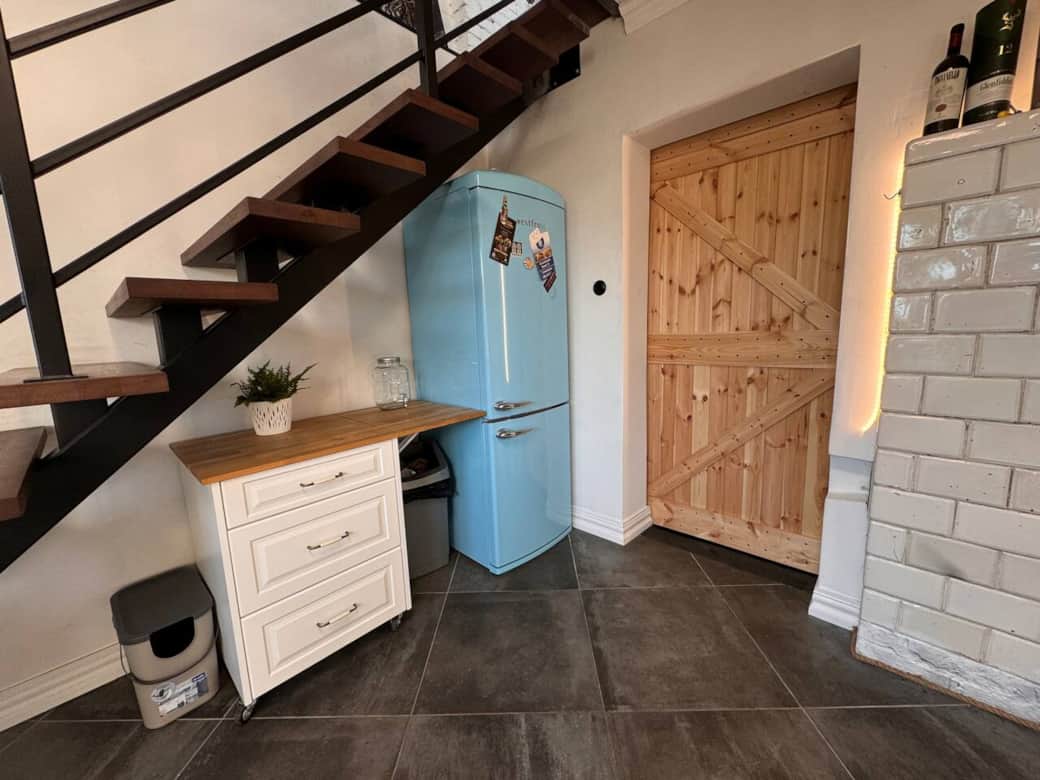 A retro styled blue fridge in kitchen A retro styled blue fridge in kitchen