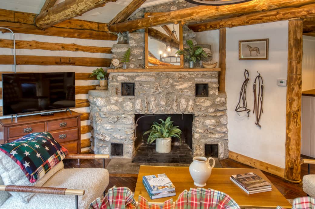 Relax in our cozy living room, decorated with rustic Americana charm and a warm stone fireplace.