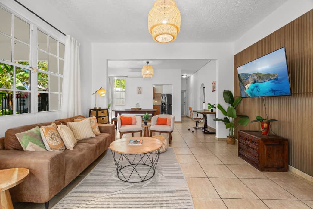 Spacious open-concept living area with smart TV and workspace