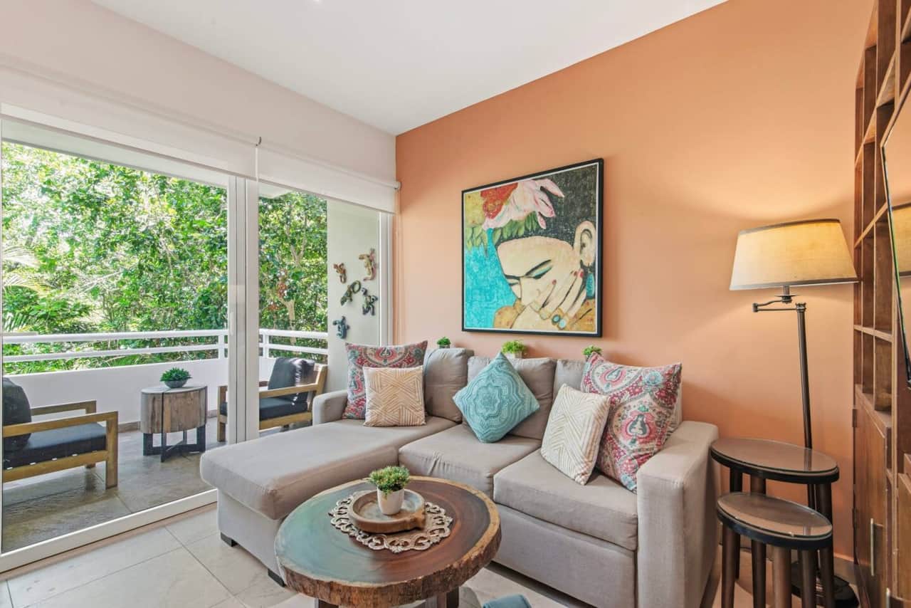 Unwind in this cozy, air-conditioned living room featuring a full-size sofa bed and room-darkening shades. Step directly onto your private balcony to enjoy a morning coffee and peaceful greenery views.