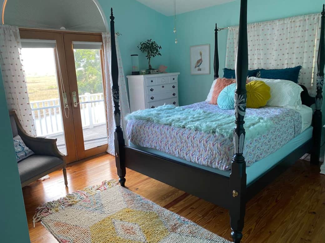 Seriah’s Suite features a queen bed and french doors that open to the rear porch with a estuary view.