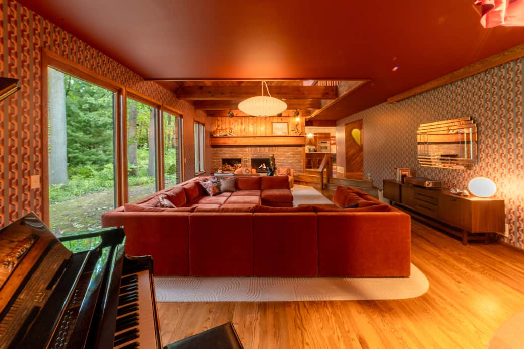 Retro sunken living room with baby grand player piano and 120” home theater Retro sunken living room with baby grand player piano and 120” home theater