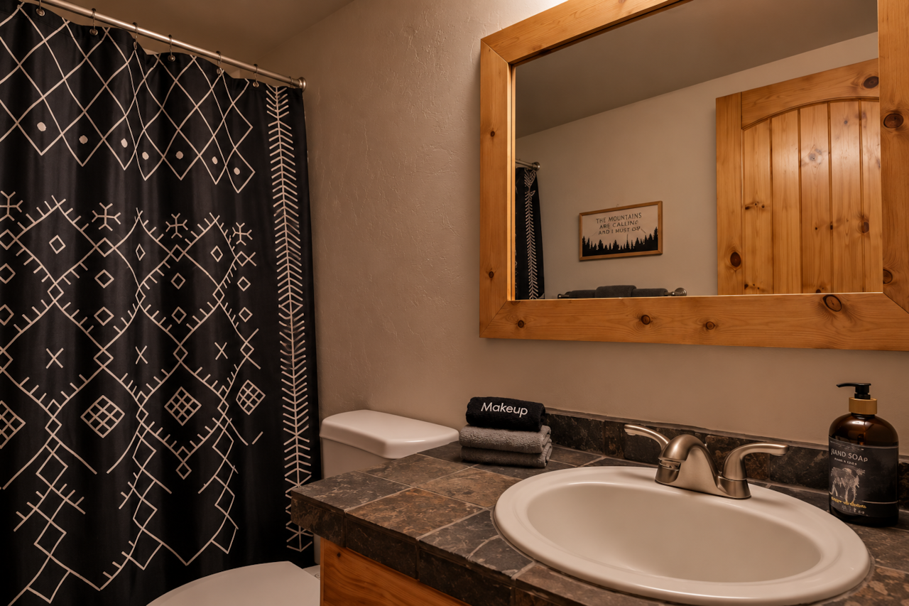 Clean bathroom vanity with modern fixtures in cabin