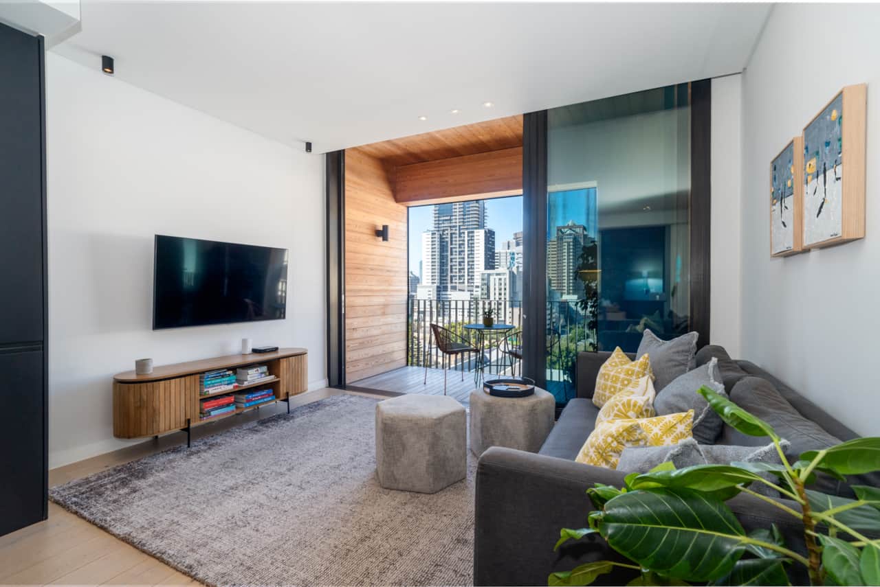 Living area opens onto balcony overlooking the city and Table Mountain