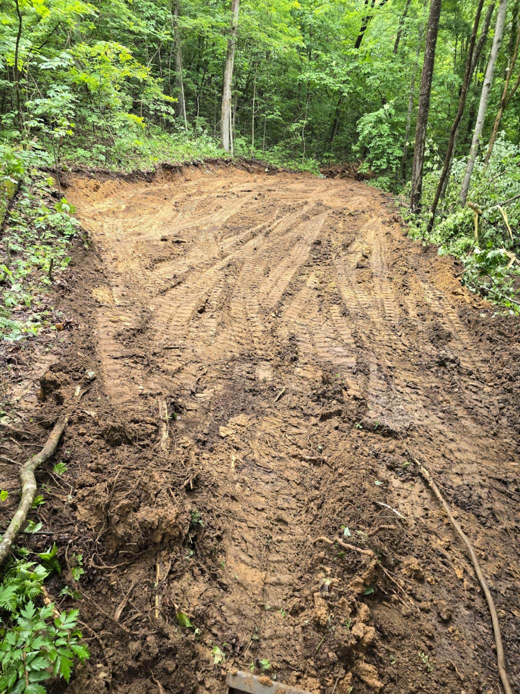 Clearing & leveling the parking area of the top of the property.