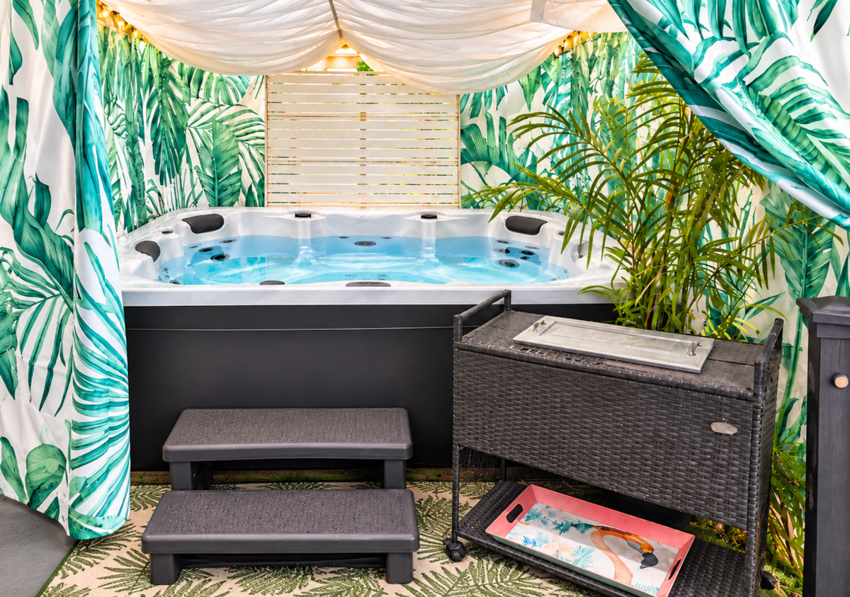 Garage lounge with hot tub, cruiser bikes, foosball, darts and beach gear at White Magnolia Galveston