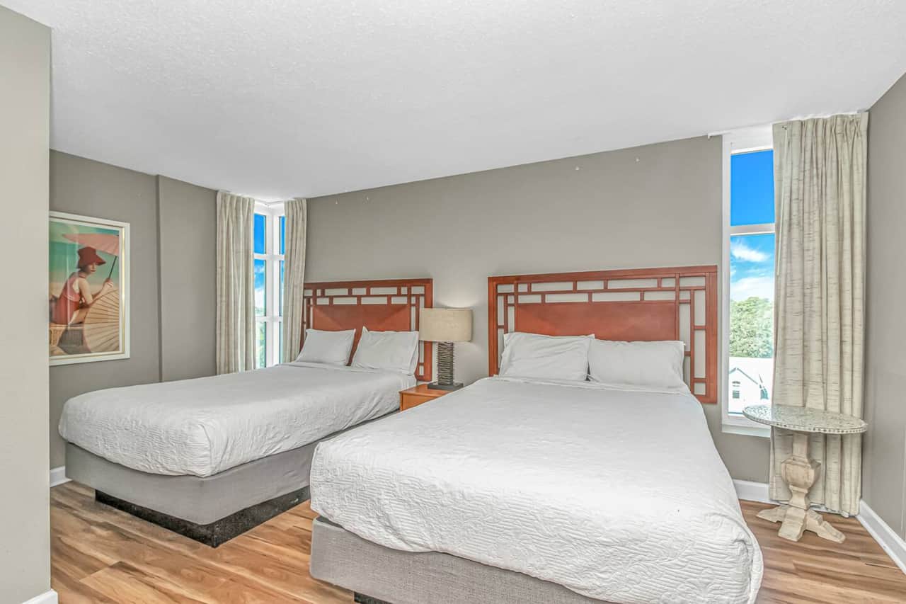 Comfortable bedroom with two queen beds and plenty of natural light