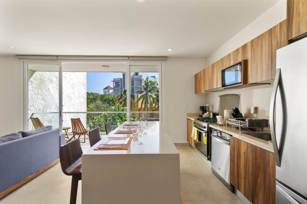Fully equipped kitchen & dining area with balcony access.