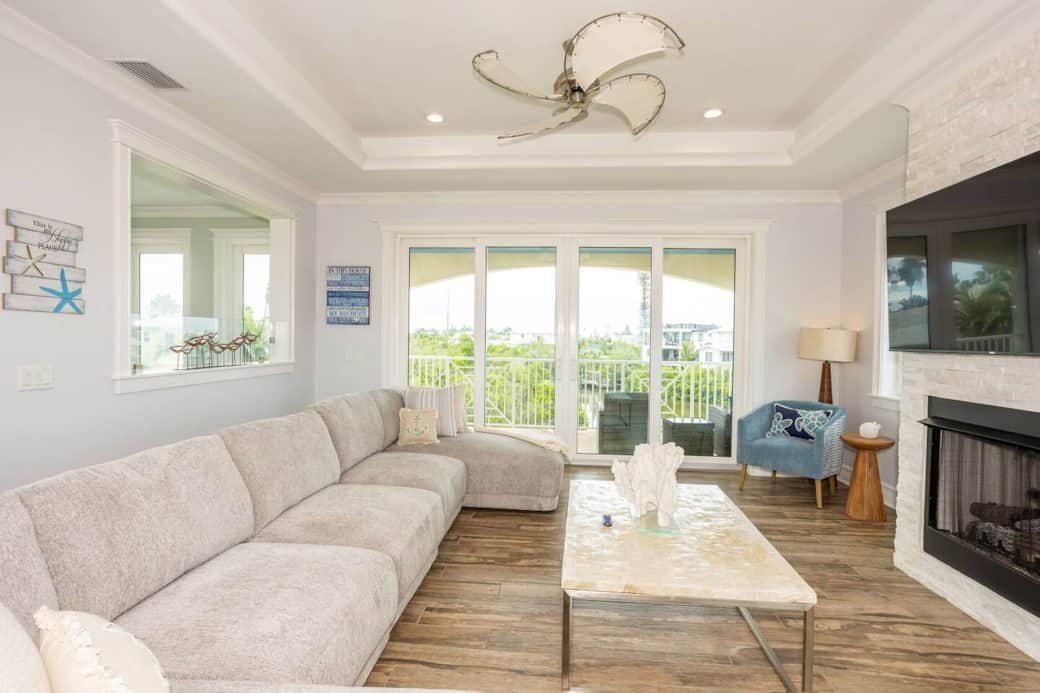 Top floor living room with oversized sofa, electric fireplace and amazing views