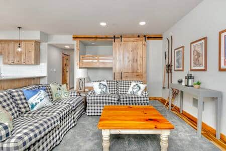 Bunks are hidden behind wood barn doors, offering additional sleeping area. Bunks are hidden behind wood barn doors, offering additional sleeping area.