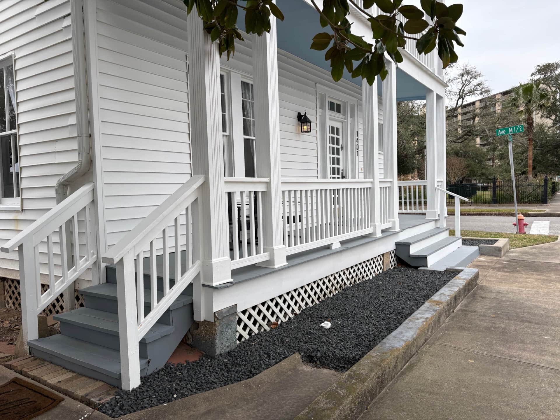 Historic 1921 exterior of White Magnolia Galveston with porches and free off-street parking.