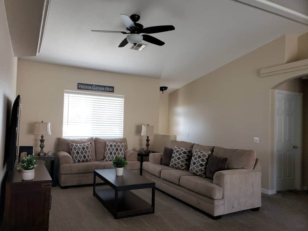 Living Room with 65" Smart TV, Ceiling Fan, Vaulted Ceiling