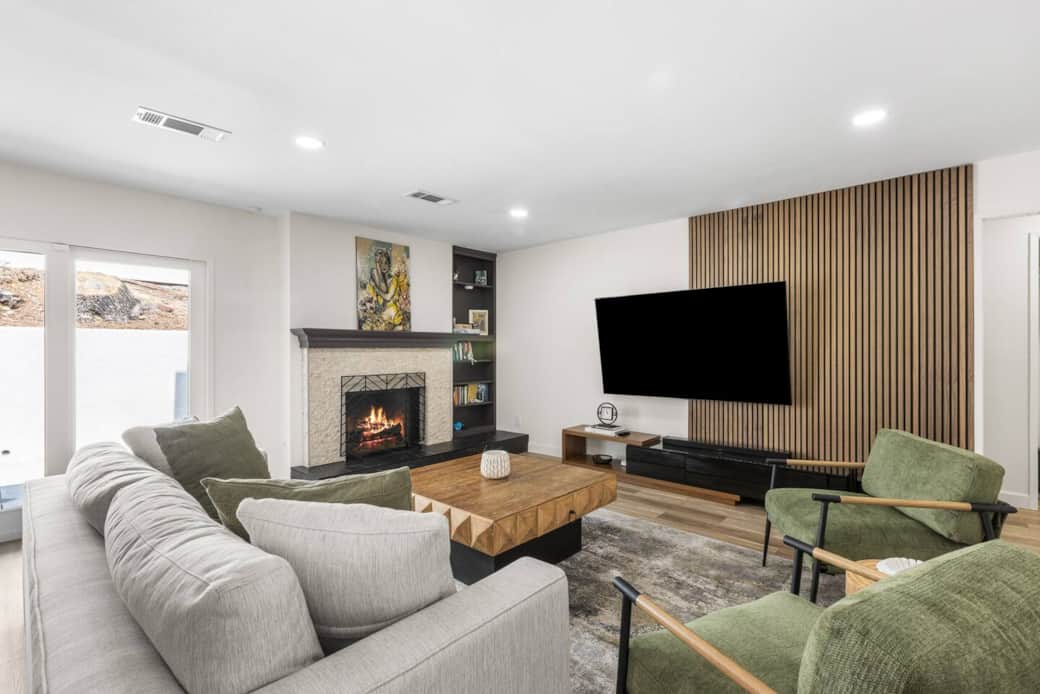 Cozy up by the modern fireplace in this stylish lounge with plush seating and a mounted TV.