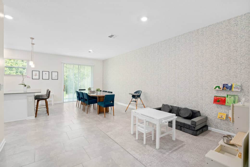The dining area connects to a family play corner, so you can cook or enjoy coffee while kids play nearby.

