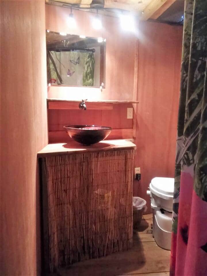 Bathroom with compost toilet, vessel sink, and HOT rain shower. 
