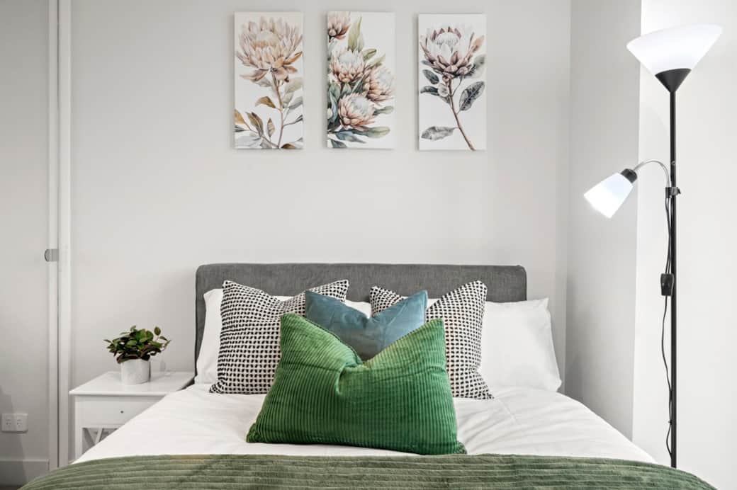 Bedroom 1 features a comfortable Double-sized bed with soft linens and plush pillows, creating a calm and inviting space to relax. The room includes bedside lighting and a clean, modern layout for a restful stay.