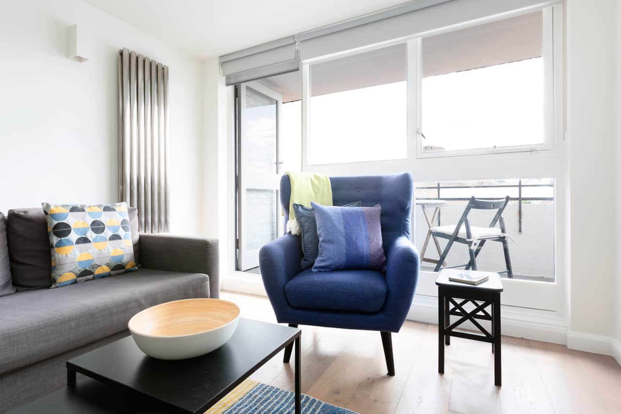 Cosy reading chair by the balcony, Tower Bridge apartment