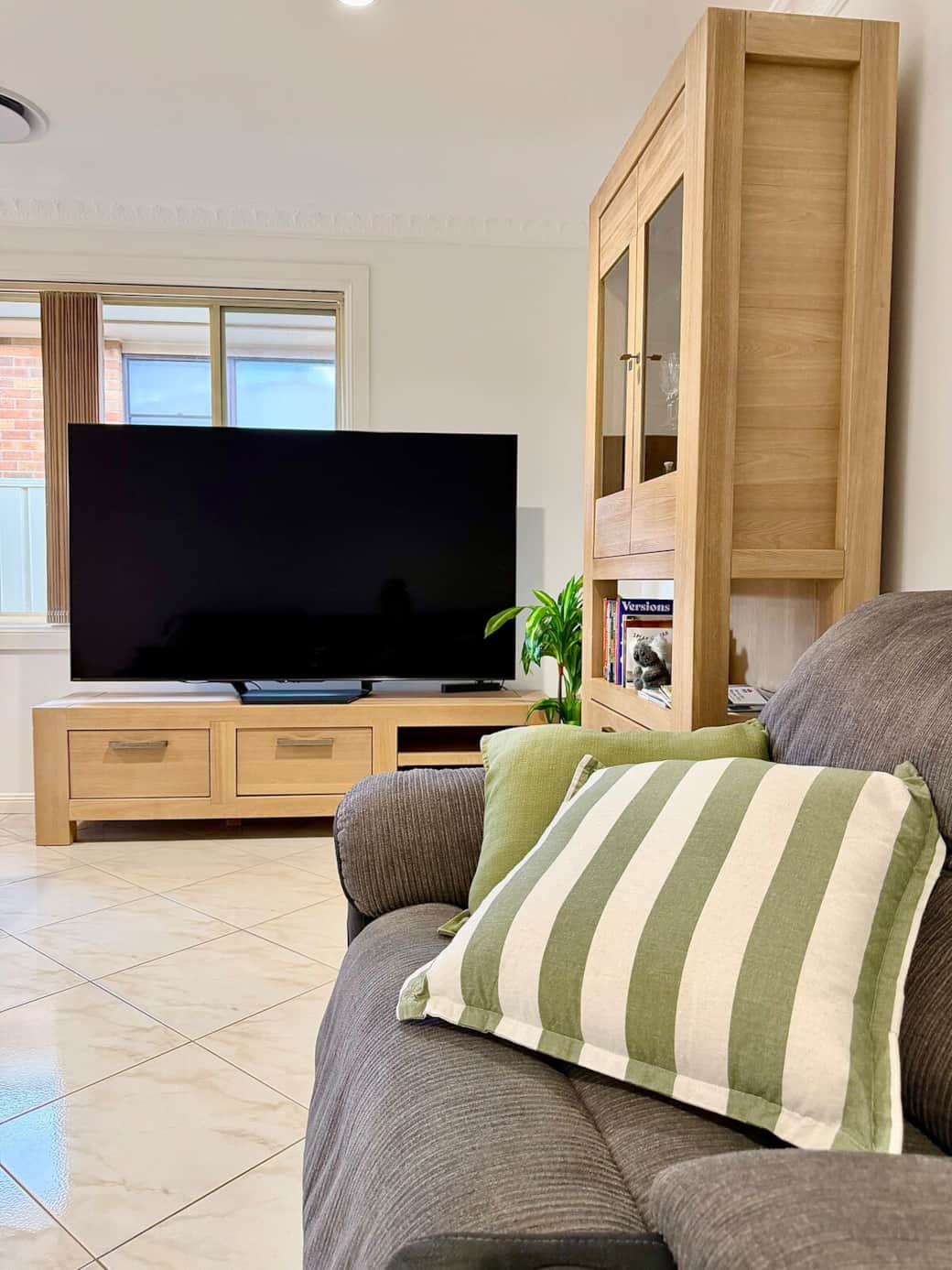 Cosy living area with a comfortable lounge, large Smart TV with Netflix and warm timber furniture. Perfect for relaxing after a day of exploring.