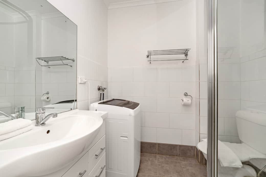 Bathroom with in-unit washing machine Flinders Street studio Melbourne Shelley Stayz