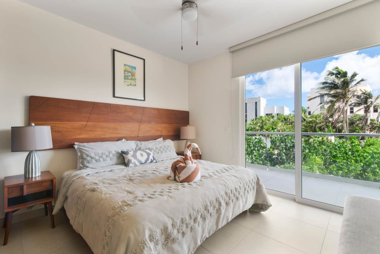 Unwind in a king bed with soft pillows as ocean breezes create a dreamy escape.