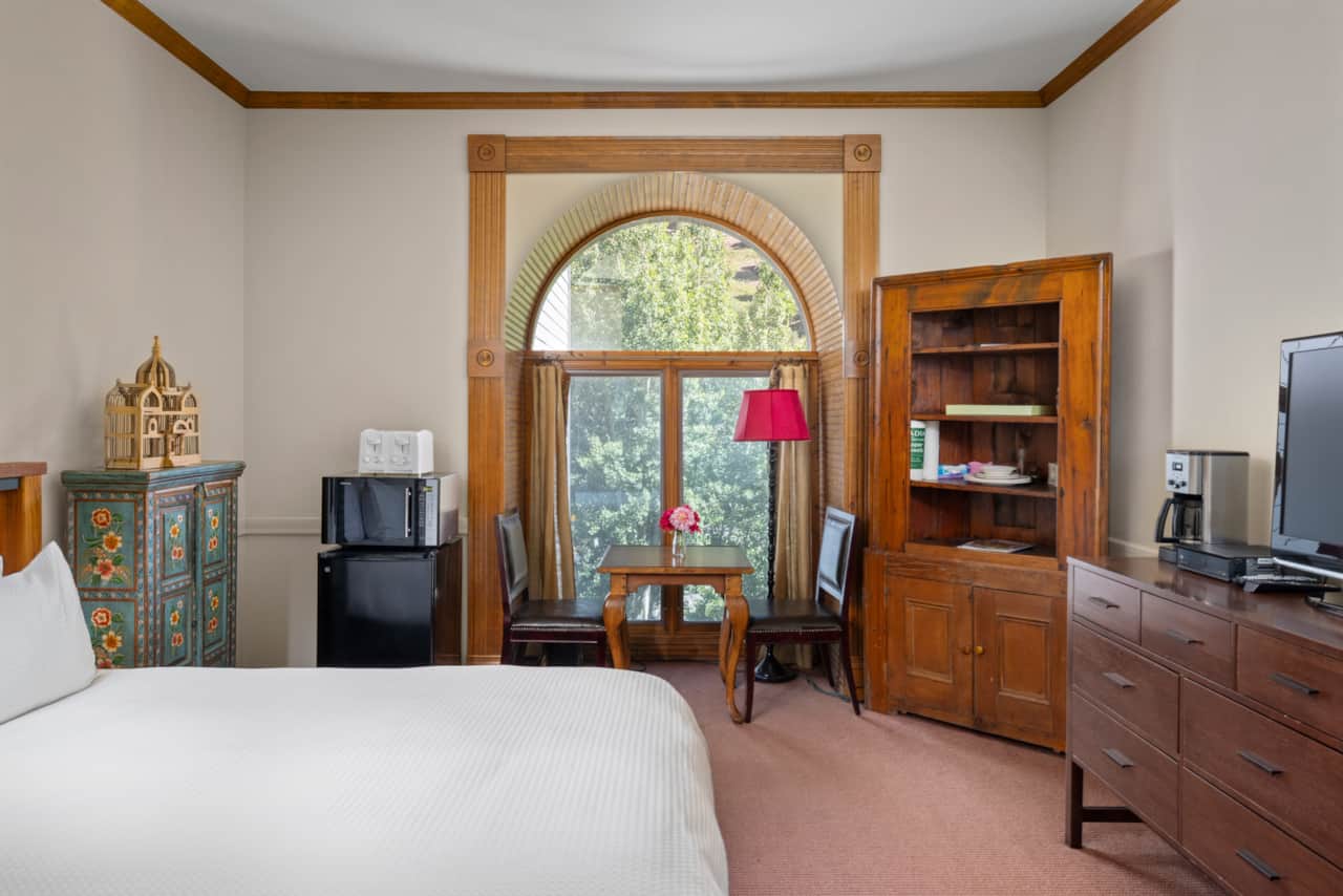Village Hideaway studio features seating area and windows with mountain views