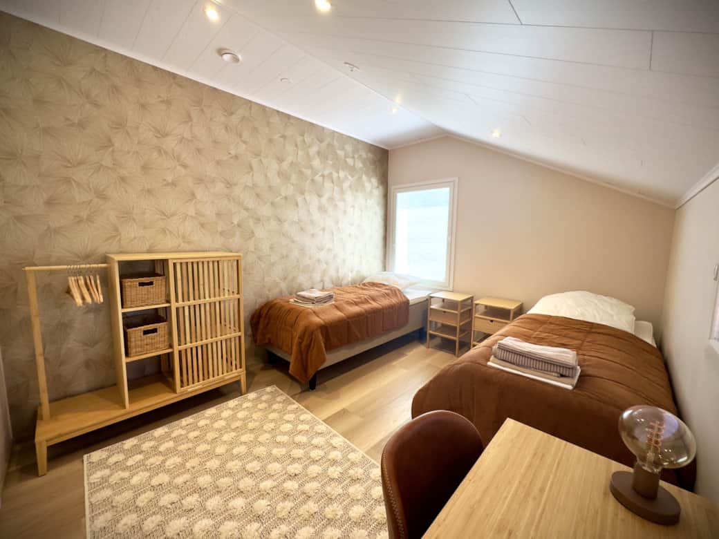 The second bedroom with two single beds and a wardrobe.
