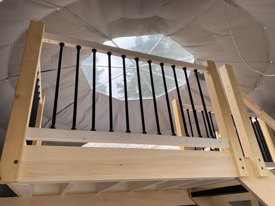 Sleep under the starry sky in a cozy queen bed.
