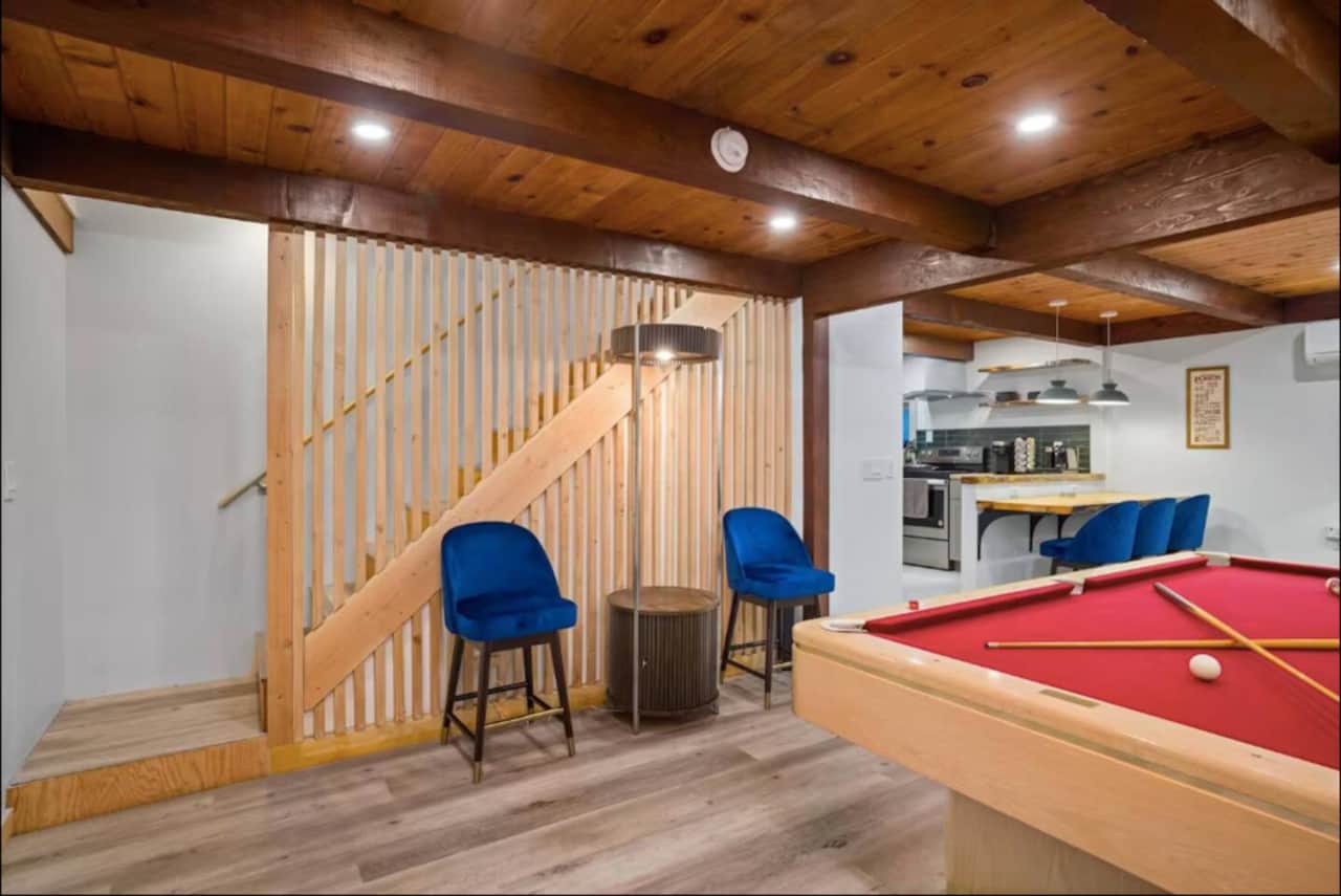 Spacious game room featuring a pool table and comfy seating, giving families and groups plenty of space to hang out and play together.