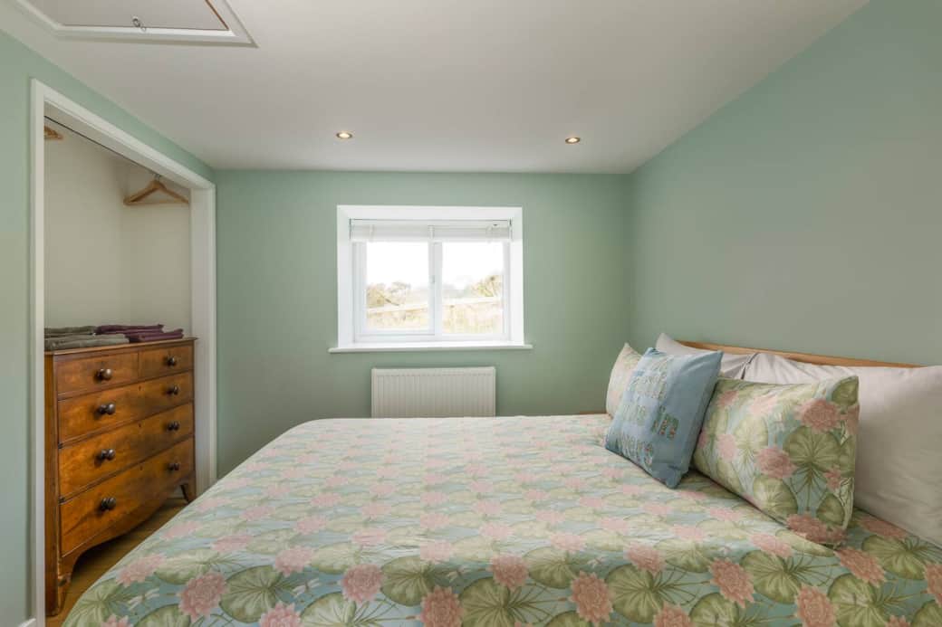 Bedroom showing storage space and window to the back garden.