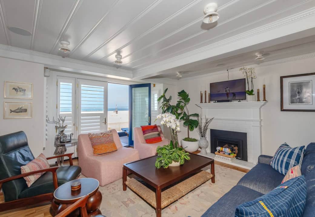The designer-appointed and comfortable living room opens up to the patio and beach.